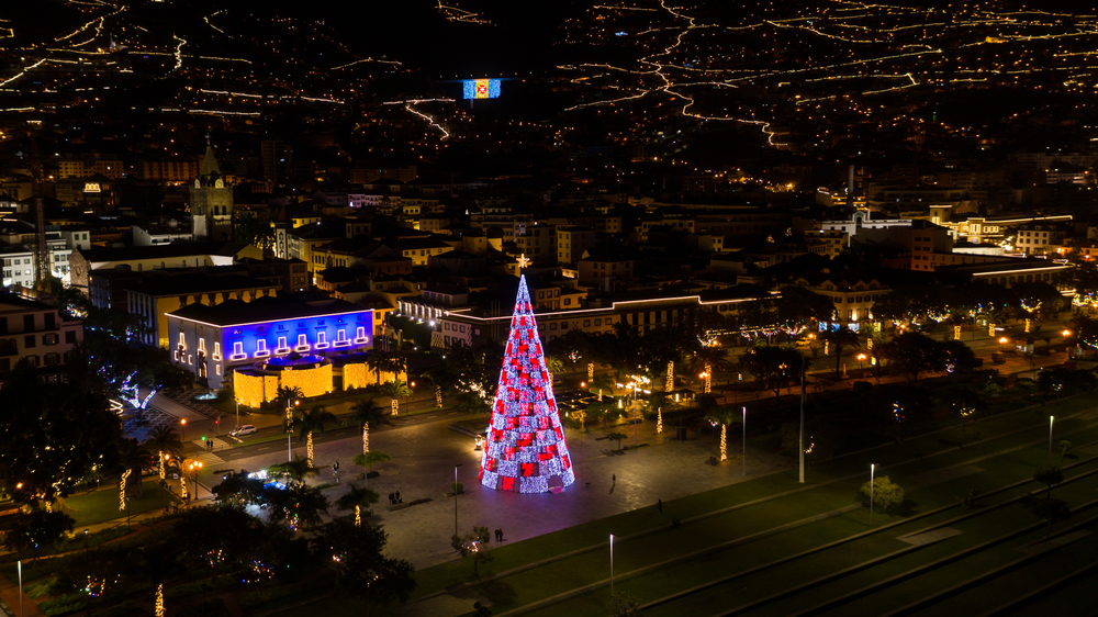 Letecký pohled na vánoční strom s kostelem Se a vlajkou Madeiry ve městě Funchal, ostrov Madeira, Portugalsko