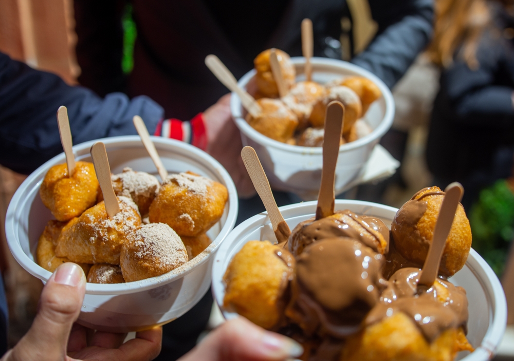 Co jíst na Korfu? Lahodná řecká jídla a speciality korfské kuchyně 9 Loukoumades, tradiční řecké koblihy podávané na bílém talíři s cukrem a čokoládovou polevou